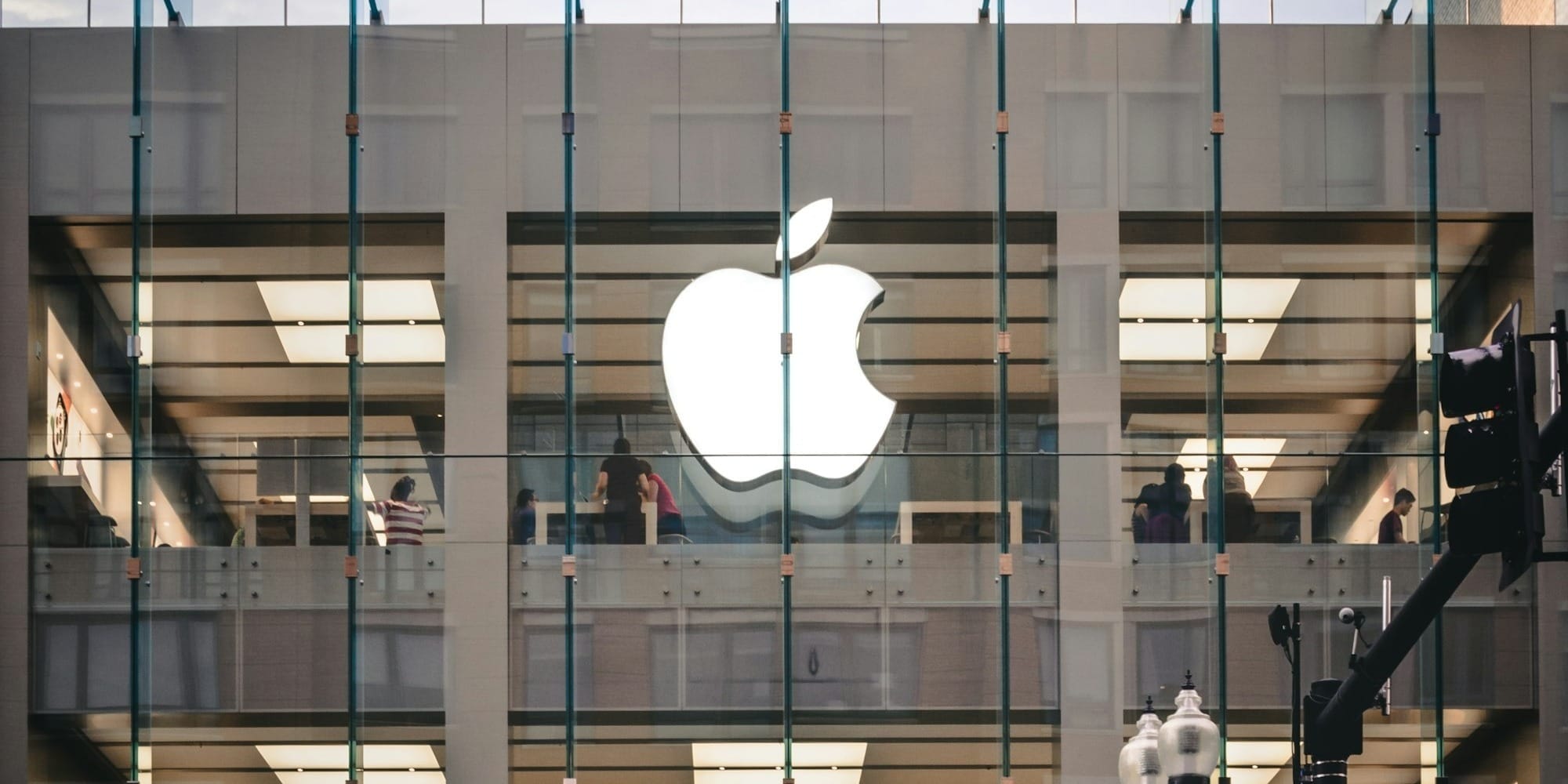 people walking beside Apple building during daytime