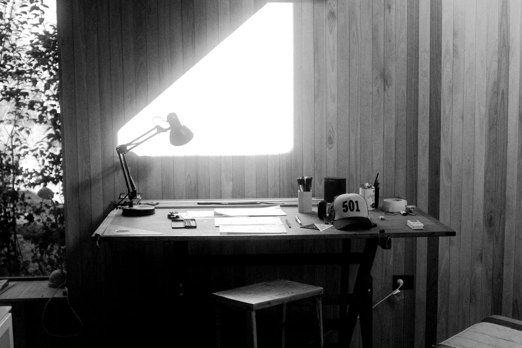 brown wooden table with black laptop computer on top