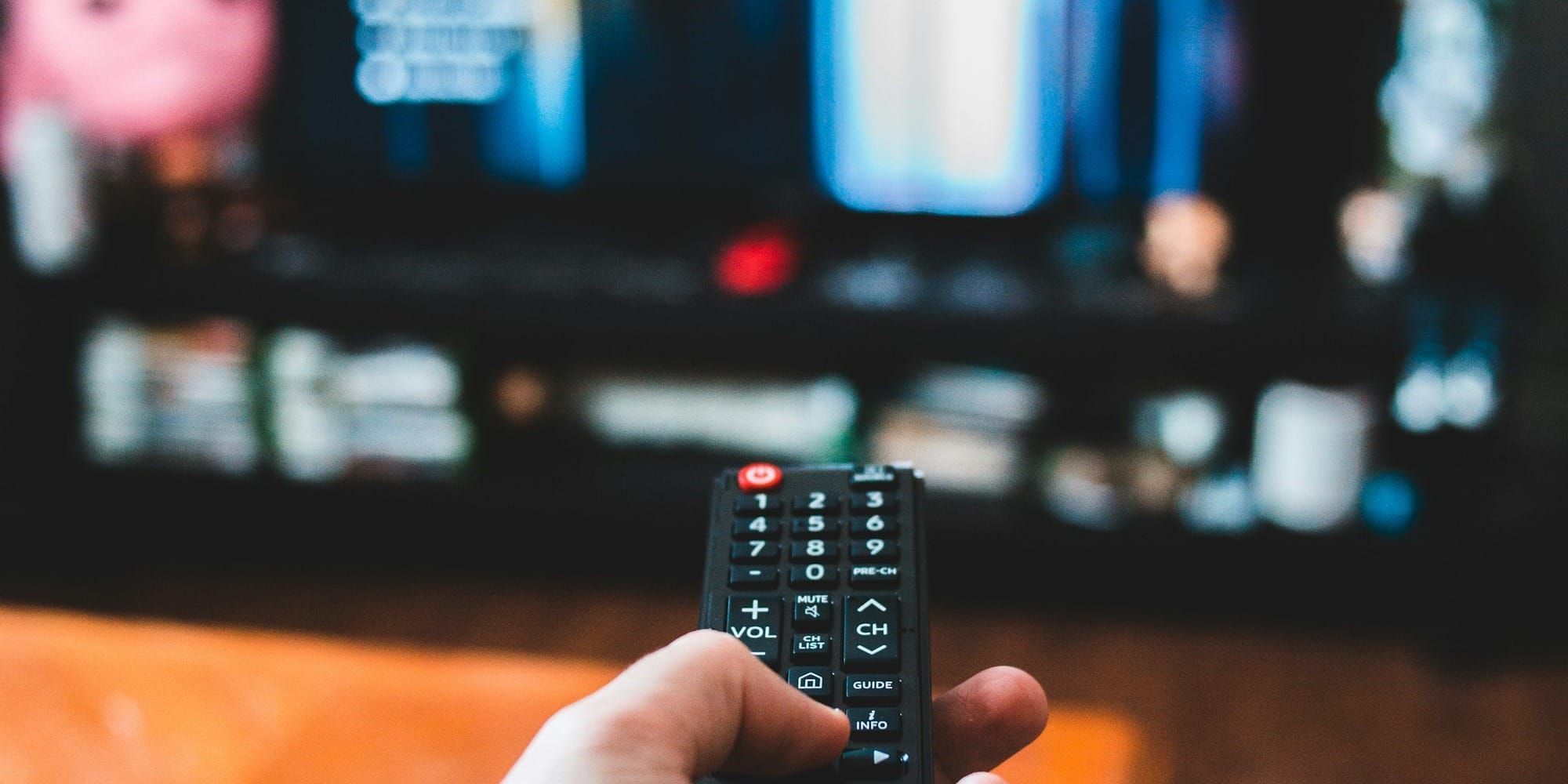 person holding black remote control