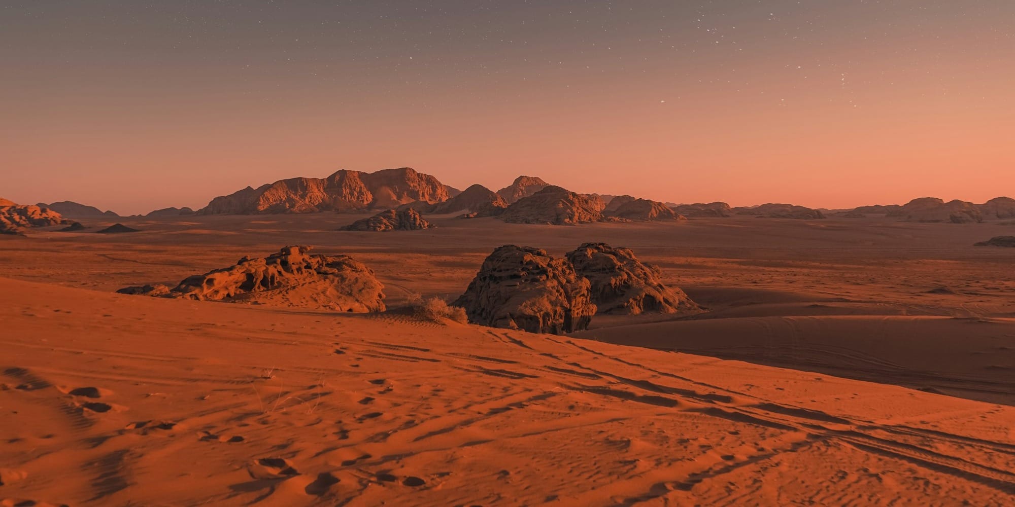 brown sand under blue sky during night time