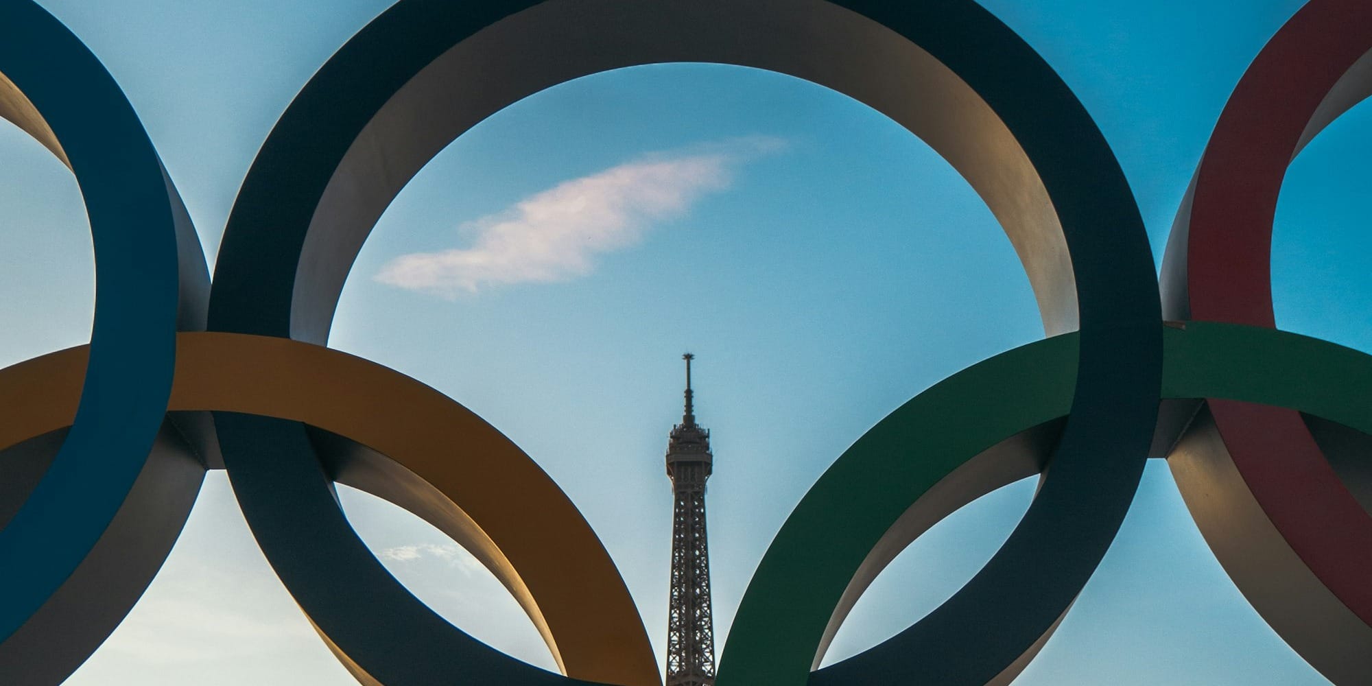 the olympic rings in front of the eiffel tower